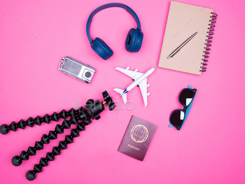 flat lay top view of traveler photographer accessories on pink background