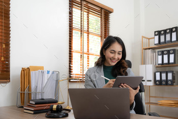 asian woman lawyer working and judge in a courtroom the gavel, working with tablet and laptop and
