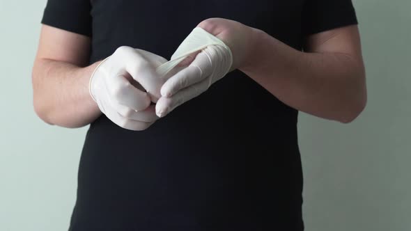 The Virologist Removes the Protective Gloves From His Hands. A Protective Measure Against