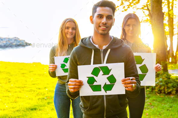 Environmental protection team holding recycling symbol placards - Stock Photo - Images