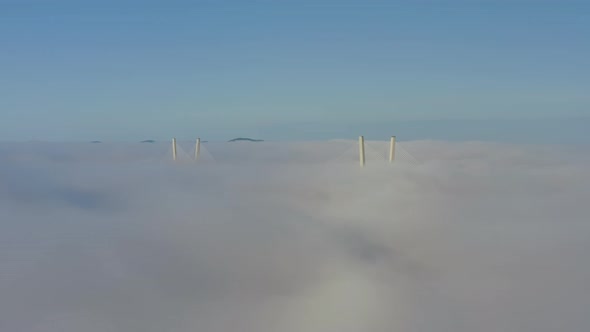 Tops of the Pylons of the Golden Bridge in the Dawn Fog in Vladivostok alt