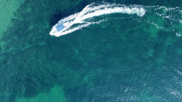 Aerial Footage Above a Passing By Speed Boat in the Turquoise Water