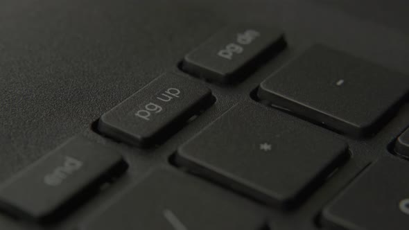 The Finger Presses the Page Up Button on the Keyboard alt