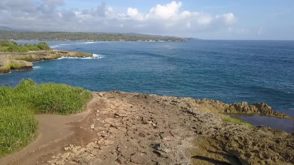 Stunning aerial view flight fly backwards drone shot.Big ocean waves crashing on the rocks of Devil alt