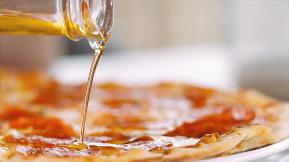 Pours Oil on Pizza Close-up