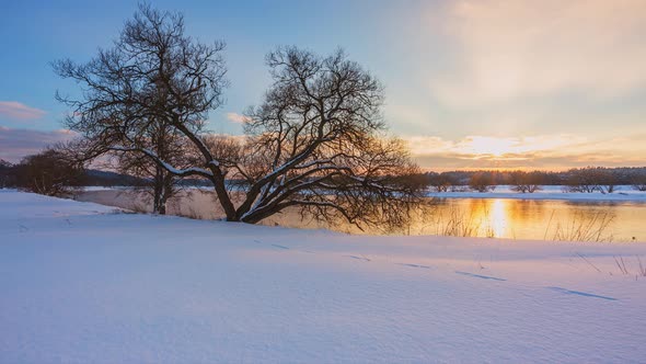 Winter Sunset Timelapse with Snow and River Stream in the Background