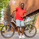 Portrait of handsome smiling stylish hipster with bike in park - PhotoDune Item for Sale
