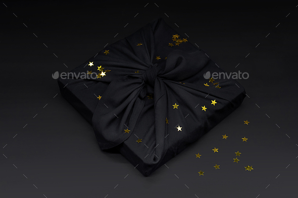 Black Friday Gift Box Wrapped in Fabric with Golden Confetti.  - Stock Photo - Images