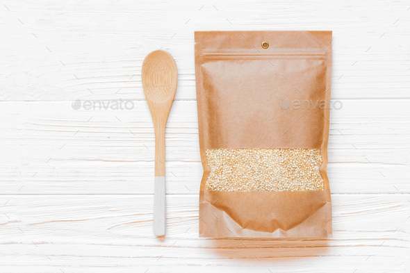 Mockup paper bag with quinoa seeds and wooden spoon