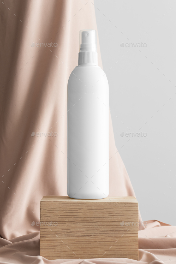 White cosmetic spray bottle mockup with a beige textile.