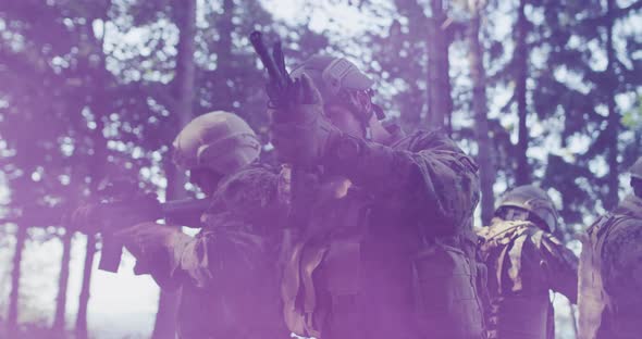 Silhouette of the Fully Equipped Soldier Moving Through Smokey Forest alt