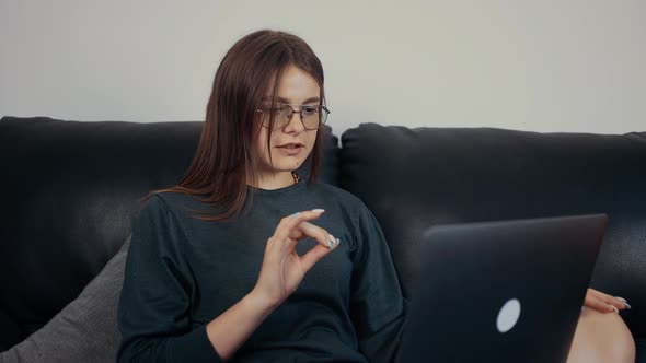 The Inspired Young Woman Red with Freckles and Glasses Teaches a Very Important Lesson Online to Her alt