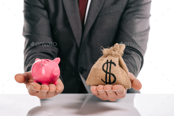 cropped view of mortgage broker holding piggy bank and moneybag isolated on white