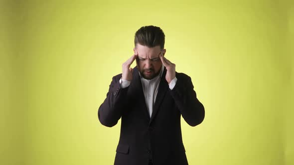 Sick Ill Bearded Man in Office Suit Putting Hands on Head Having Headache