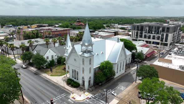 Aerial establishing shot of Christian church building and steeple in southern USA. Aerial approach. alt