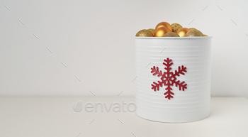 a cone full of golden Christmas balls with white background and space for copying