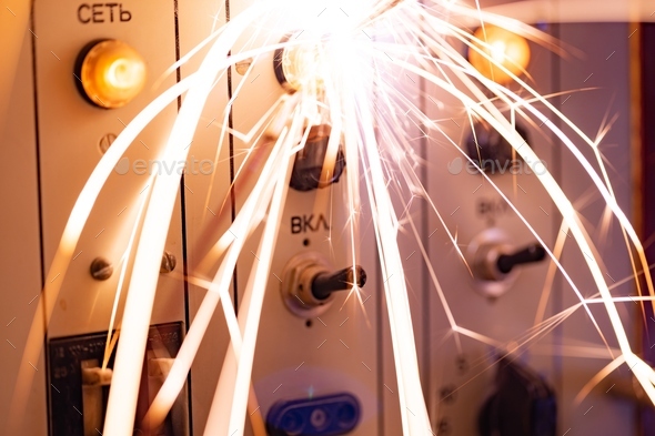 Electronic sparks scatter quickly and sharply from a short circuit on technological equipment