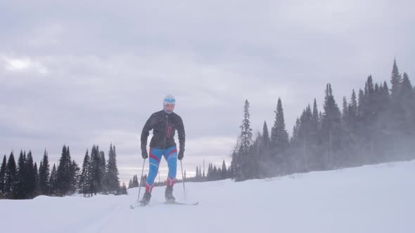 Young woman skiing on a forest trail