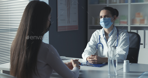 Doctor with surgical mask meeting a patient