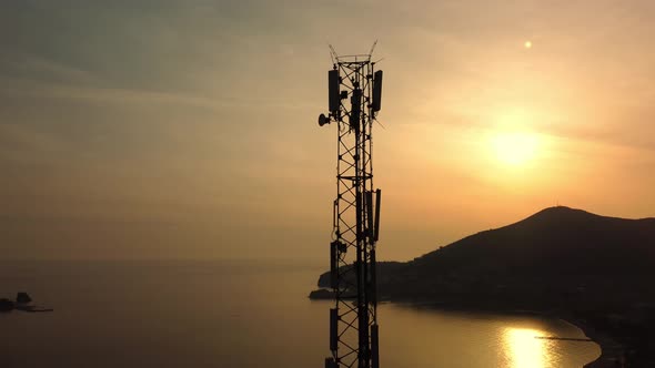 Amazing closeup sunset drone view of silhouette of cell tower