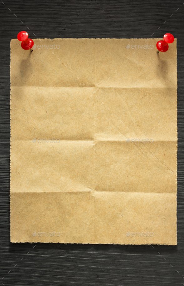 folded note paper on wood