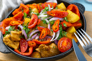 Pork ojakhuri with vegetables. Meat, potatoes, onions, herbs, peppers cooked and served in a skillet