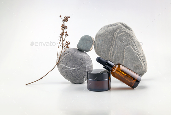 abstract composition of balancing stones, bottles for cosmetics and dried flowers