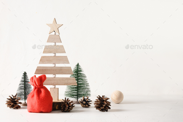 Creative wooden Eco Christmas tree and pine cones on white background. DIY. - Stock Photo - Images