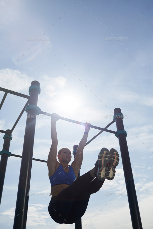 Fit woman hanging on bar Stock Photo by Media_photos PhotoDune