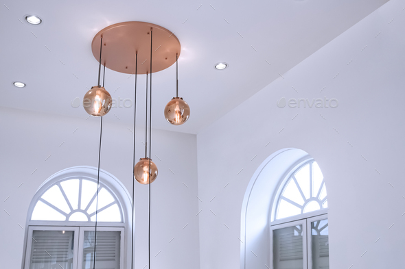 Modern ceiling round rose gold glass chandelier with arch wooden windows inside of white living room