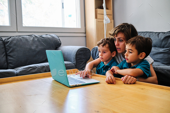 a mother using a computer to teach their children at home