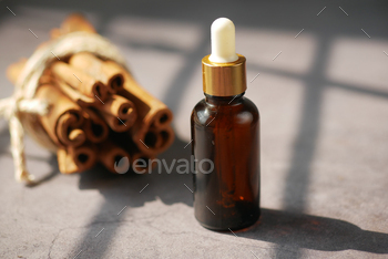  cinnamon essential oil in a container with sun light 
