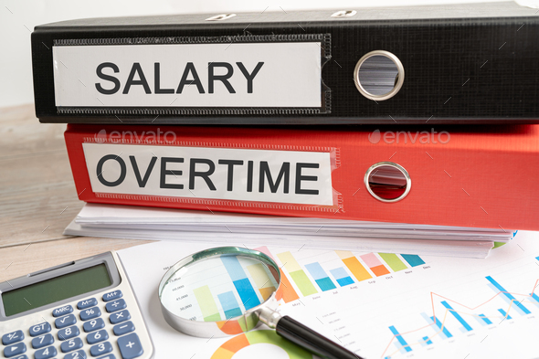 Salary overtime. Binder data finance report business with graph analysis in office.