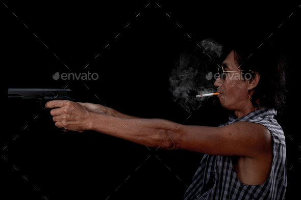 Portrait Asia old man hand holding a pistol gun