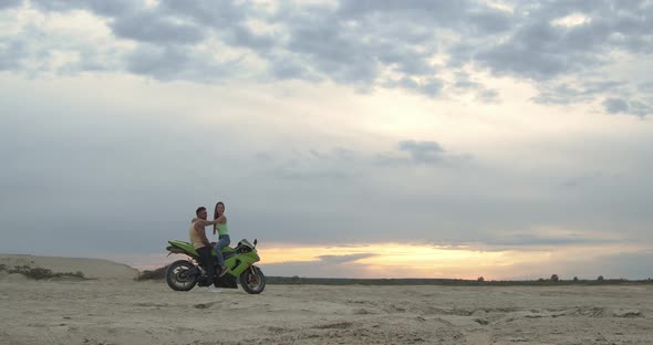 Stylish Couple on Motorbike on Beach