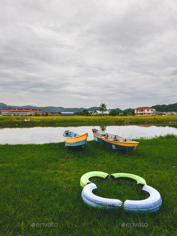 Fishing boats and wooden house on shore of Perlis, Malaysia. Stock