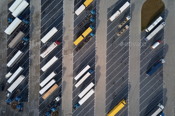 Top view of trucks on parking lot near logistic warehouse