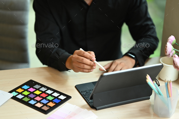 Male interior designers working with digital tablet and color palette ...