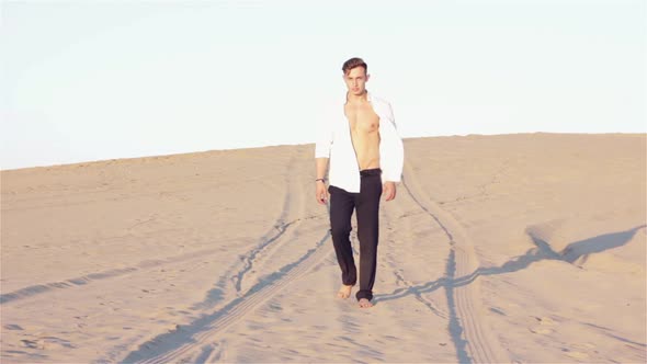 Sexy Man is Walking in Desert