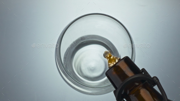 Craft beer filling glass closeup. Refreshing ale jet bubbling pouring vessel