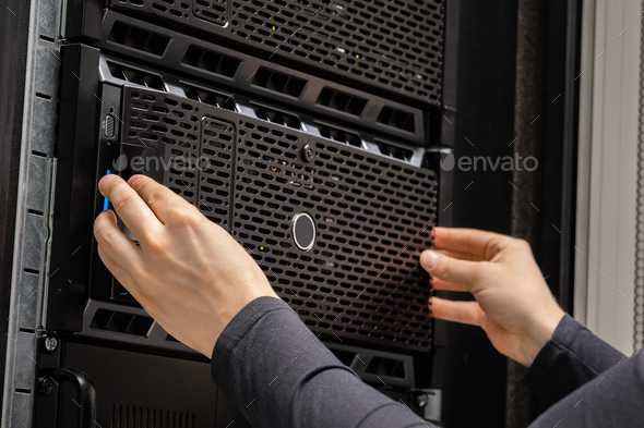 Close-up of hands Of IT Consultant Installing Servers In Datacenter - Stock Photo - Images
