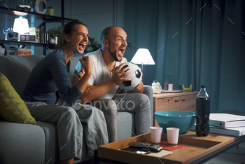 Football fans watching a match on TV