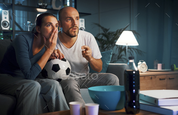 Soccer fans watching the match on TV