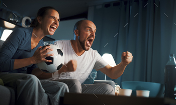 Football fans watching a match on TV
