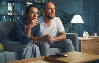 Couple watching a drama movie on TV