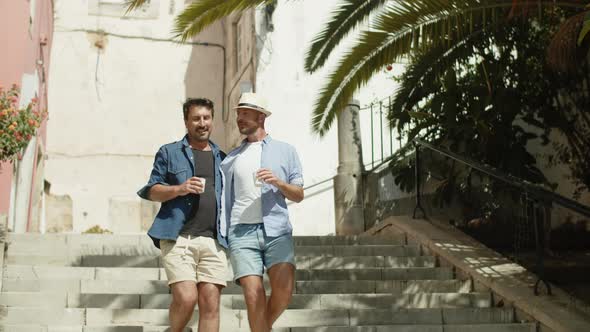 Long Shot of Smiling Homosexual Men Going Down Stairs in Street alt
