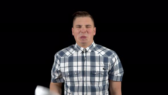 A Young Man Takes Off His Mask and Shows an Emotion of Disgust on His Face. The Man Is Unpleasant alt