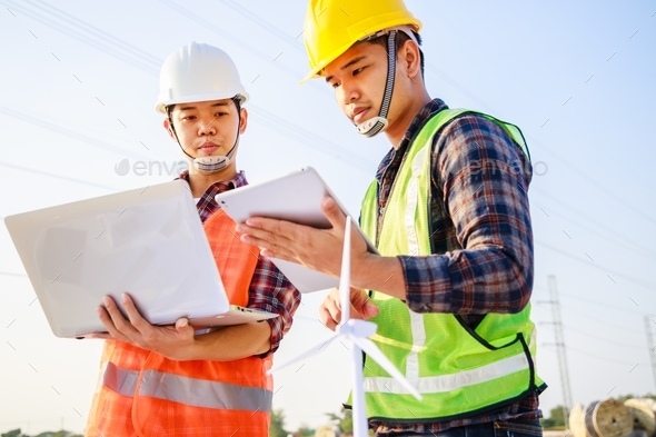 Two Asian engineer managers discussed together on construction site ...