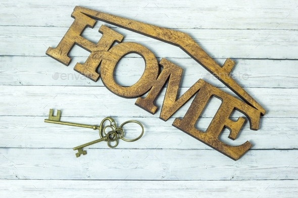Concept of housing acquisition, the key and the word house on a wooden background	 - Stock Photo - Images