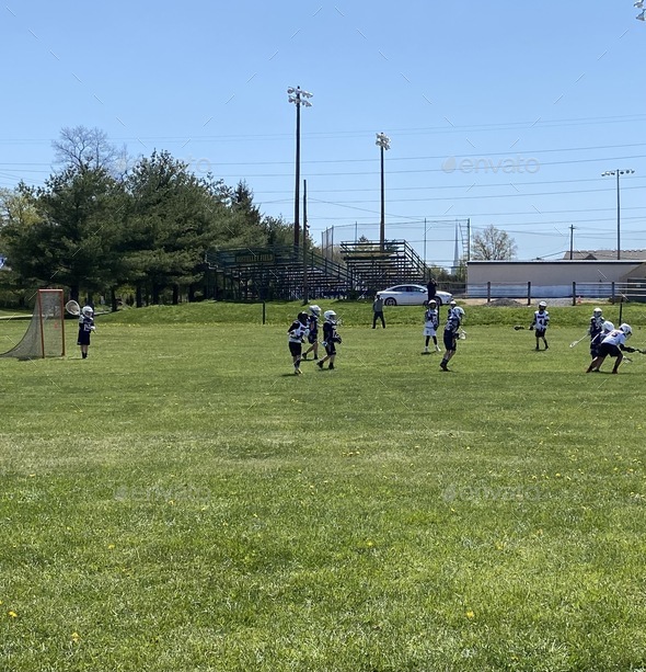 Boys lacrosse game in lacrosse field